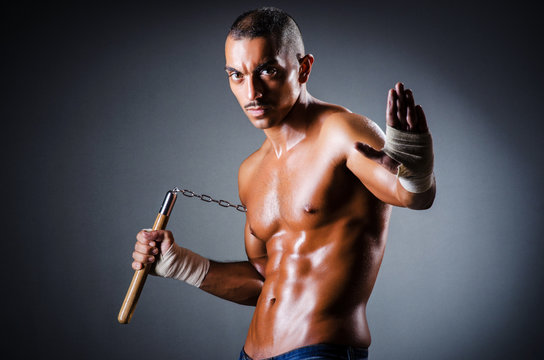 Strong man with nunchaku