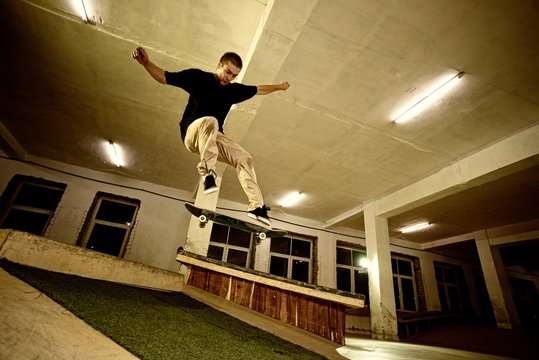 Young man performing a stunt in a skatepark