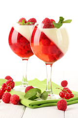 fruit jelly with berries in glasses on wooden table