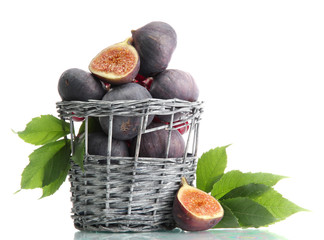 Ripe sweet figs with leaves in basket isolated on white