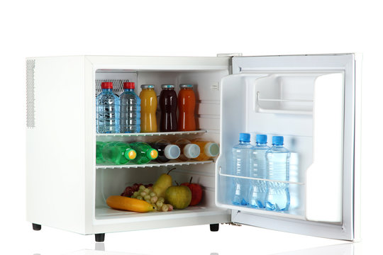 mini fridge full of bottles of juice, soda and fruit isolated