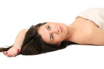 Naklejka premium A beautiful young woman lying, isolated on white background