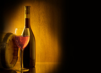Red wine glass and Bottle on a wooden background