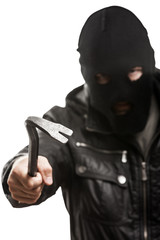 Fototapeta premium Criminal thief or burglar man in balaclava or mask holding crowb