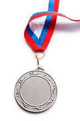 Metal medal with tricolor ribbon..