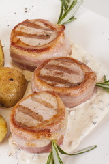 Grilled steak wrapped in bacon, with grilled vegetables, mashed