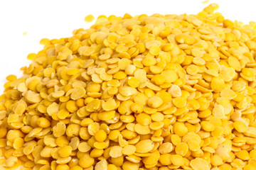 Yellow lentils isolated on white background. Macro shot