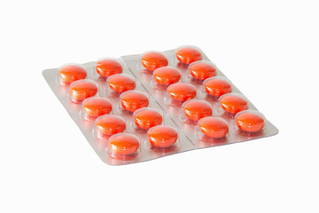 Blister of orange pills isolated on white