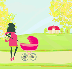 beautiful pregnant woman pushing a stroller