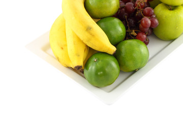 Fresh mixed fruit focus green orange on white background.
