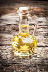 bottle of olive oil on wooden background