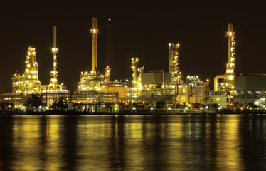 Oil refinery plant night scene nearby river in Thailand