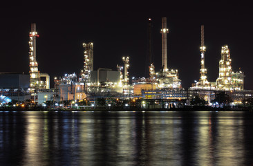 Oil refinery plant night scene nearby river in Thailand