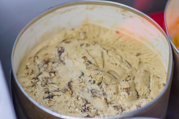 Ice cream in metal jar under shopping window in cafe