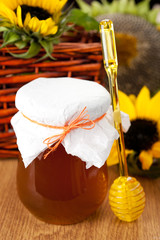 Jar of honey and flowers sunflowers
