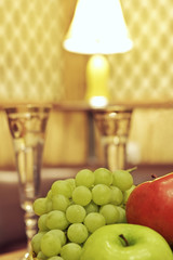 Fruit and glasses on table in interior