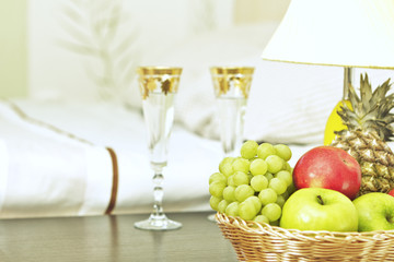 Fruit and glasses on table in interior
