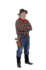 Smiling old cowboy stands with arms crossed