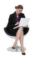 Businesswoman using a laptop in a chair