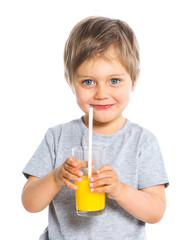 Portrait of little boy drinking orange juice