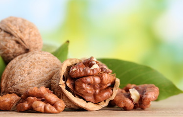 walnuts with green leaves, on green background