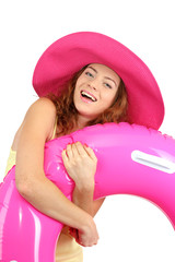 Smiling beautiful girl with beach hat  and rubber ring isolated