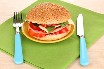 Appetizing sandwich on color plate isolated on white