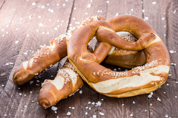 Pretzels with salt on wood