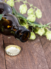 Bottle of Beer with Hops on wood