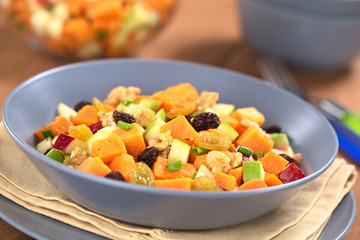 Salad made of sweet potato, apple, nut, raisin, shallot