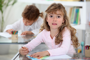 two kids studying in a classroom