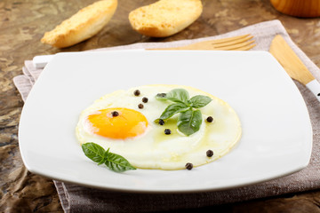 Fried egg with pepper and basil