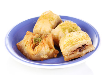 Sweet baklava on plate isolated on white