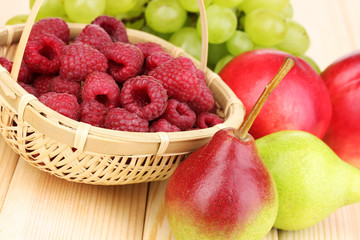 ripe sweet fruits and berries on wooden background