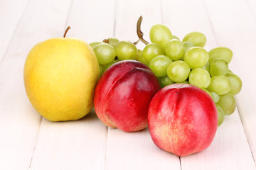 ripe sweet fruits and berries on wooden background