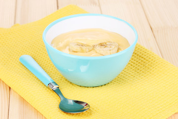 Yogurt with banana on wooden table