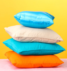Colorful pillows on yellow background