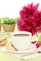 cup hot chocolate, cookies  and flower on table in cafe