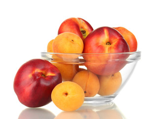 Ripe fruit in glass bowl isolated on white