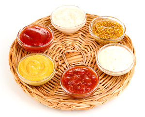 various sauces on wicker mat isolated on white © Africa Studio