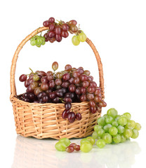 Delicious ripe pink and green grapes in basket isolated on
