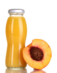 Delicious peach juice in glass bottle and peach next to it
