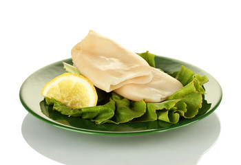 boiled squids with lettuce and lemon in the plate isolated