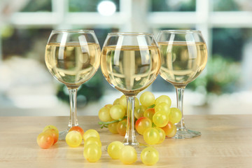 White wine in glass on window background