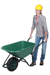 Woman pushing empty wheelbarrow