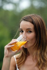 Woman drinking juice outdoors