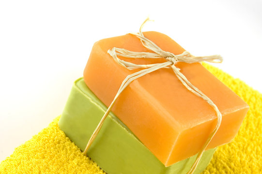 Two bars of natural sandal and olive soap on white