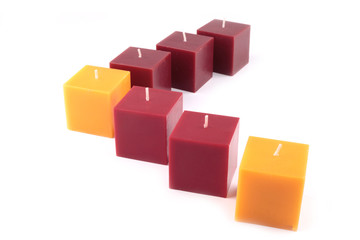 Fototapeta premium Yellow and red candles on a white background