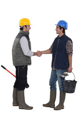 Construction workers shaking hands