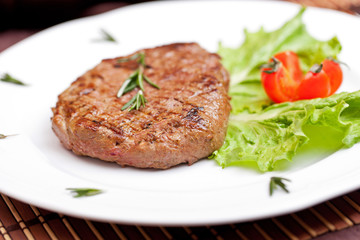 Grilled steak on a white plate
